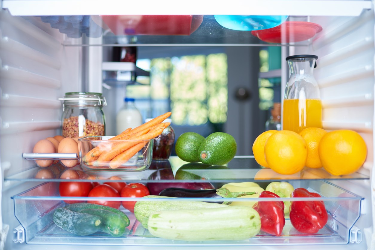 The inside of a refrigerator, filled with fresh fruits and vegetables. 