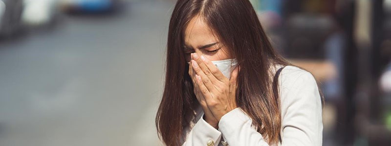 Woman blowing her nose in public. 