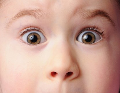 Close up of a little girl's shocked face. 