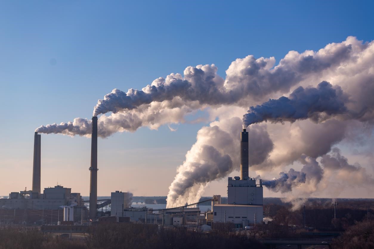 Factory building with smoke coming out of the top.