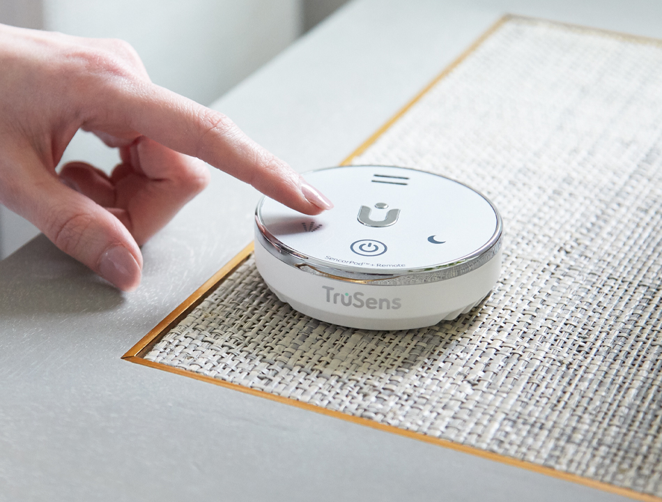Person adjusting the TruSens humidifier remote SensorPod