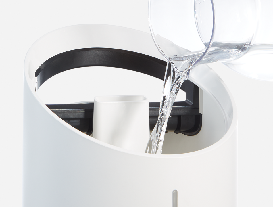 Filling up humidifier with pitcher of water