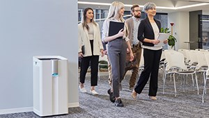 TruSens Performance Series Air Purifier with a group of people walking by